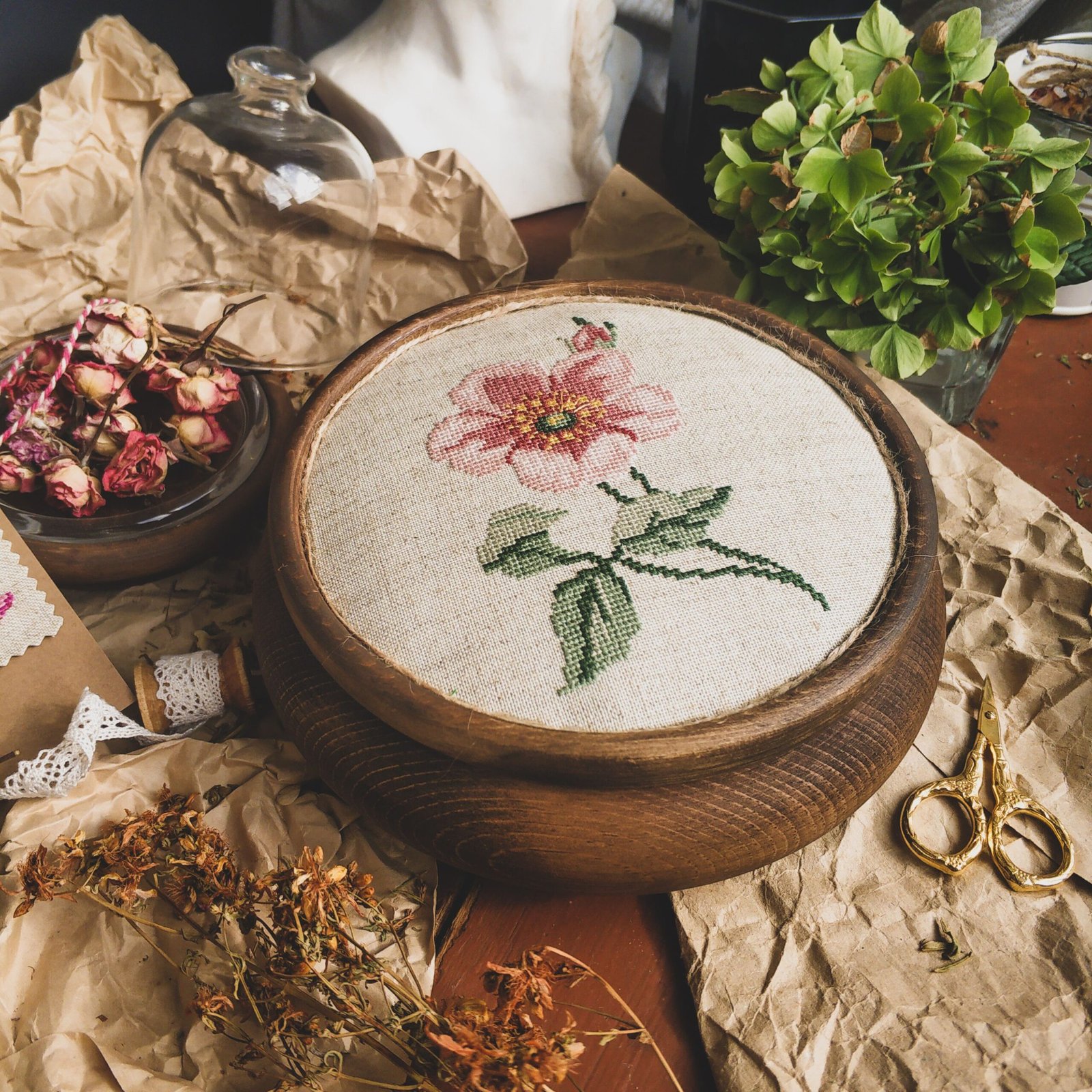 Detailed cross-stitch embroidery of a flower, showcasing intricate handmade craft.